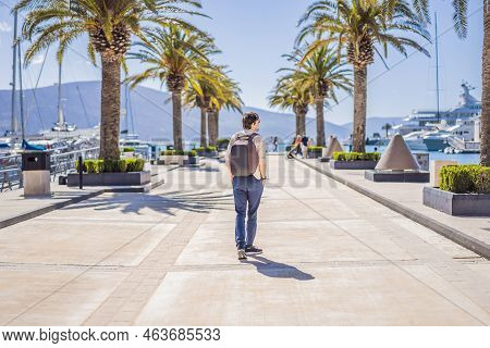 Man Tourist On Background Of Yacht Marina, Beautiful Mediterranean Landscape In Warm Colors. Montene