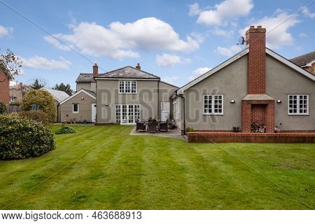 Stradishall, England - March 21 2016: Extended Traditional Detached Cottage From Rear Within Garden