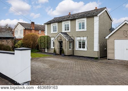 Stradishall, England - March 21 2016: Detached Traditional Cottage With Paved Driveway And Garage