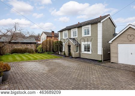 Stradishall, England - March 21 2016: Detached Traditional Cottage With Paved Driveway And Garage