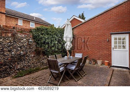 Stradishall, England - March 21 2016: Walled Courtyard Garden With Table And Chairs