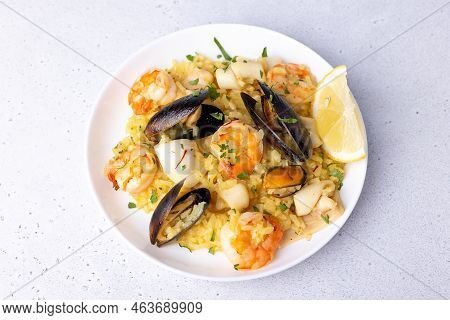 Seafood Risotto With Saffron, Parsley And Lemon. Arborio Rice With Tiger Prawns, Mussels And Squid. 