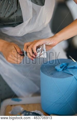 Close Up On Hand Squeezing Paint Tube