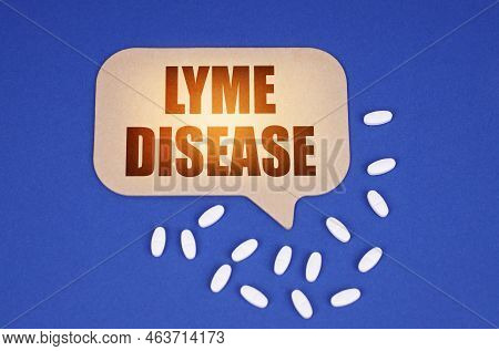 Medical Concept. On The Blue Surface Of The Tablet And A Cardboard Plate With The Inscription - Lyme