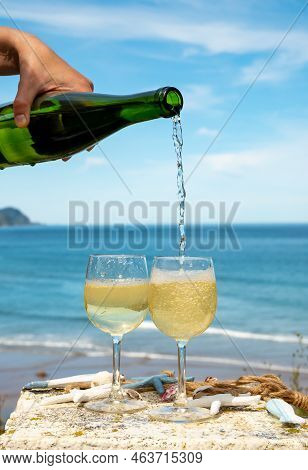Pouring Of Txakoli Or Chacolí Slightly Sparkling Very Dry White Wine Produced In The Spanish Basque