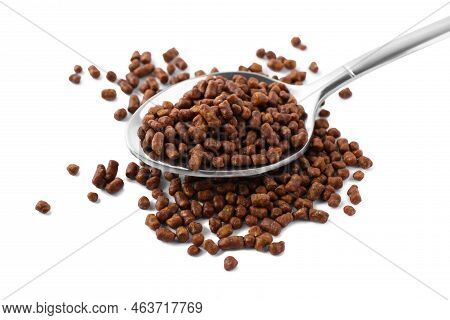 Spoon With Buckwheat Tea Granules On White Background