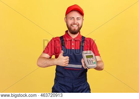 Smiling Positive Worker Man Holding In Hand Pos Contactless Payment Terminal, Using Paypass For Purc