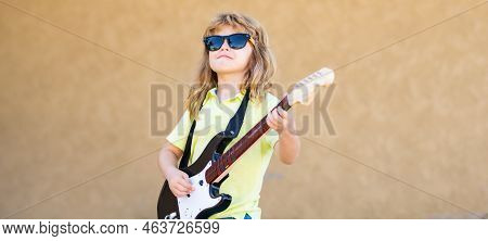Kid With Guitar. Portrait Of Cute Child Boy At Guitar Practice, Funny Rock Child With Guitar. Childr
