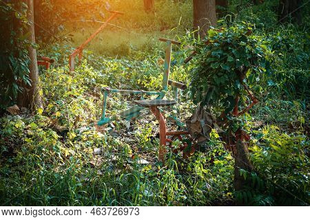 Old Outdoor Exercise Equipment So Worn Out And Covered In Trees In Outdoor Exercise Park. Old Abando