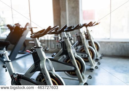 Fitness Center Club With Training Exercise Bikes. Modern Gym Interior With Equipment. Workout With S