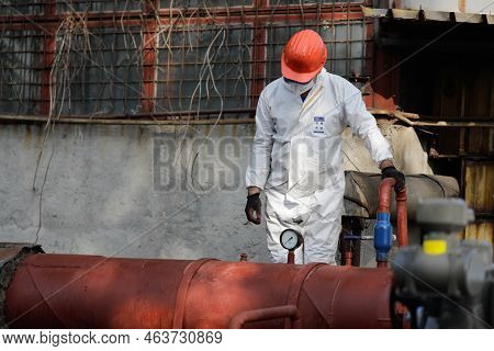 Bucharest, Romania - October 13, 2022: Worker At A Hot Water Metallic Pipeline.