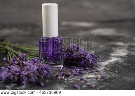 Bottle Of Essential Oil And Lavender Flowers On Wooden Table. Lavandula Oleum For Cuticle, Copy Spac