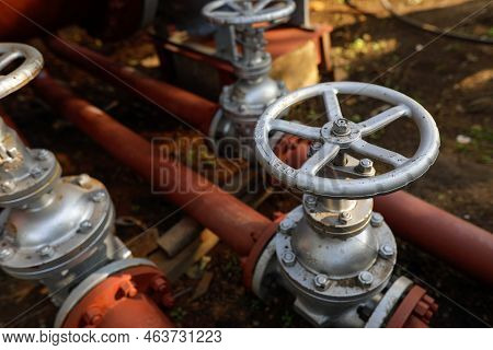 Shallow Depth Of Field (selective Focus) Details With Industrial Metallic Pipe Valves Used To Open O
