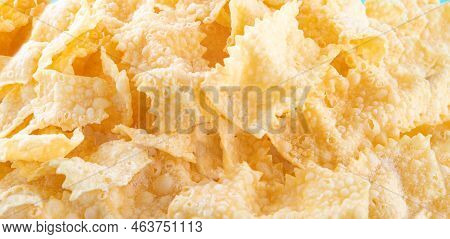 Sfrappole Or Chiachiere Or Angel Wings Background. Italian Carnival And Typical Food. Traditional Sw