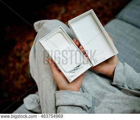 London, United Kingdom - Sep 28, 2022: Pov Woman Hand Holding The Package Showing Empty Apple Comput