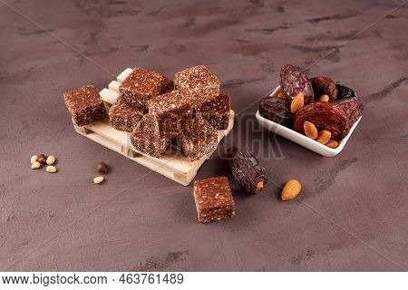 Healthy Energy Candies In The Form Of Cubes On A Pallet. Nearby Are The Ingredients (dates, Dried Ap