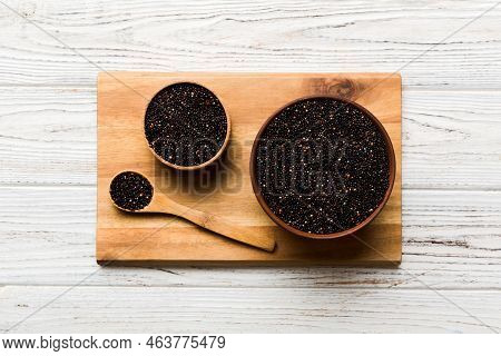 Quinoa Seeds In Bowl And Spoon On Colored Background. Healthy Kinwa In Small Bowl. Healthy Superfood