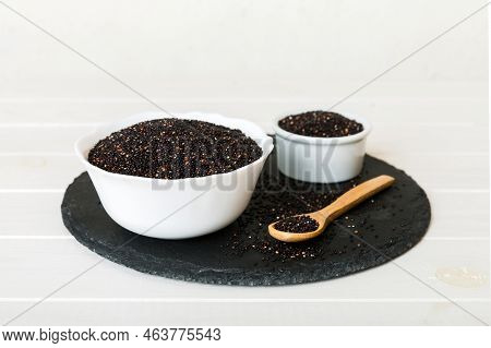Quinoa Seeds In Bowl And Spoon On Colored Background. Healthy Kinwa In Small Bowl. Healthy Superfood