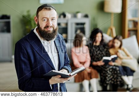Waist Up Portrait Of Bearded Jewish Man Wearing Kippah And Looking At Camera Holding Book, Copy Spac