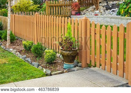 Nice Wooden Fence Around House. Wooden Fence With Green Lawn. Entrance Gate. Street Photo, Nobody, S