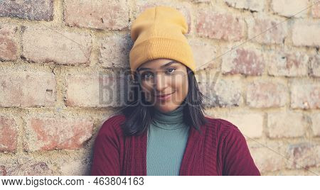 Smiling Latin American Young Adult Woman With Bobble Hat Outdoor In City In Winter