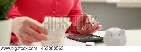Close-up Of Female Accountant Count Numbers On Calculator, Stacks Of Coins On Office Desk. Calculati