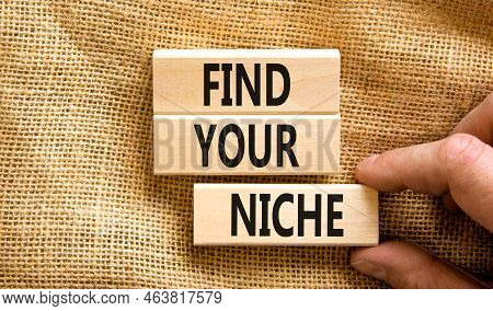 Find Your Niche Symbol. Concept Words Find Your Niche On Wooden Blocks. Businessman Hand. Beautiful 