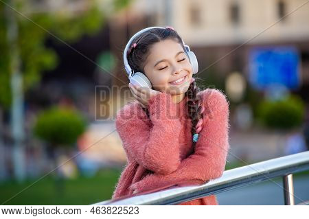 Happy Teener Enjoy Listening To Music. Melomaniac Teenager Listening Song Outdoors