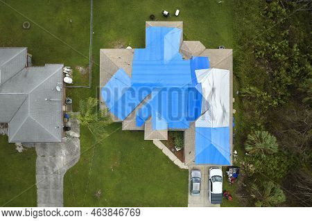 Hurricane Ian Damaged House Rooftop Covered With Protective Plastic Tarp Against Rain Water Leaking 