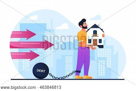 Home Debt Concept. Man Stands In Shackle With Building In His Hands. Metaphor Of Debt And Financial 