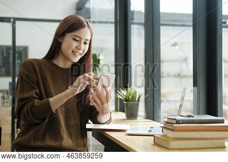 Young Asian Female Student Or Worker Learning Or Working Online Using Laptop And Giving A Confused F