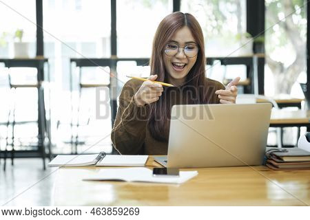 Young Asian Female Student Or Worker Learning Or Working Online Using Laptop And Giving A Confused F