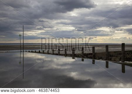 Moody Reflections On Chalkwell Beach, Near Southend-on-sea, Essex, England, United Kingdom