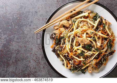 Korean Japchae Stir-fried Glass Noodles And Vegetables Closeup On The Plate On The Table. Horizontal