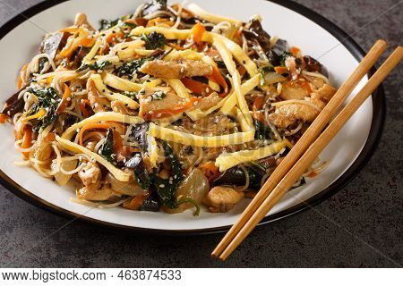 Korean Japchae Stir-fried Glass Noodles And Vegetables Closeup On The Plate On The Table. Horizontal