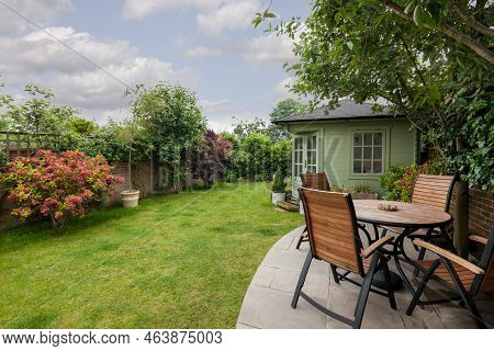 Newmarket, Suffolk, England - May 30 2018: Traditional House Landscaped Garden With Shed, Patio Tabl