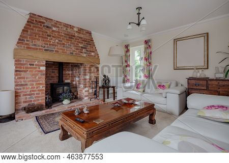 Stoke By Clare, Suffolk, England - May 19 2017: Modern Bright Furnished Living Room With Brick Ingle