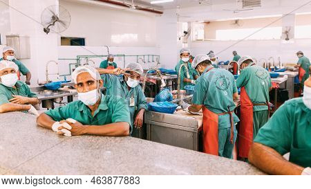 Ajman, Uae, United Arab Emirates - May 26, 2021: Ajman Fish Market. Men Cleaning Fresh Fish At Fish 