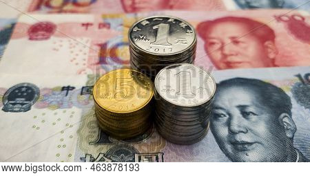Cny. Heaps Of Chinese Coins On Chinese Banknotes. Chinese Money. 5 Jiao, 1 Yuan And 1 Jiao Close-up.