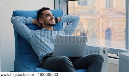 Young Arabic Professional Working On Laptop, Dreaming, Create New Idea. Smiling Millennial Indian Em