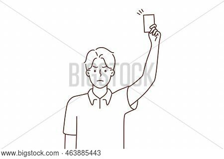 Angry Young Male Referee Showing Red Card At Football Field. Mad Man Judge Make Warning During Game.