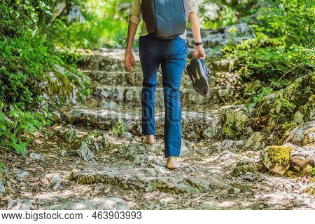 Man Tourist Climb Barefoot The Mountain To The Ostrog. It Is A Tradition To Climb Barefoot. Monaster