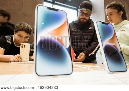 Paris, France - Sep 22, 2022: Modern New Iphone 14 Pro And 14 Plus Customers In Background Inspectin