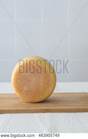 Whole Round Partmesan Or Pecorino Cheese Head On Wooden Board On Light Background. Fresh Dairy Produ