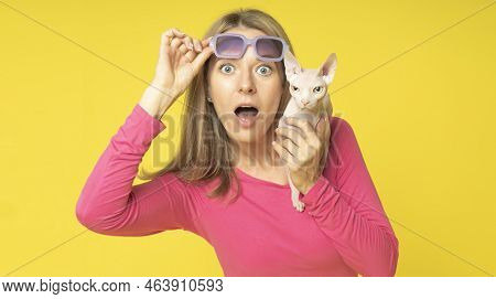 Impressed Shocked Young Attractive Woman Wearing Red Dress And Holding Sun Glasses On Her Head With 