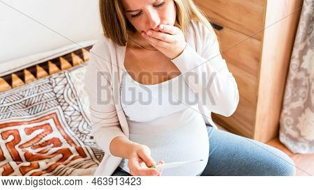 Pregnancy Fever Temperature Check. Pregnant Woman Holding Thermometer, Check Fever Flu Temperature. 