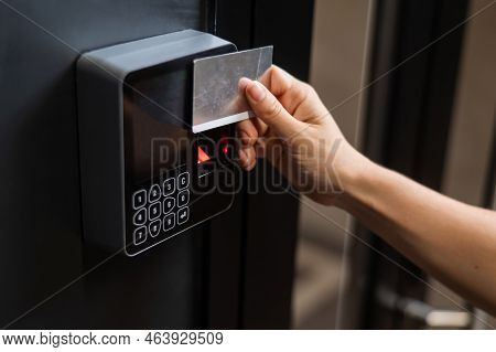 A Woman Opens The Door With A Plastic Card. Modern Keyless Entry Lock.