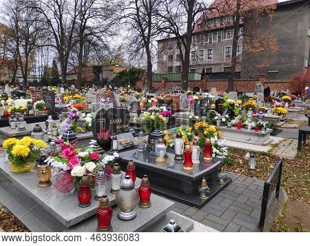 Bytom, Poland - November 7, 2021: Candles Lit On The Graves At A Cemetery In The Week After All Sain