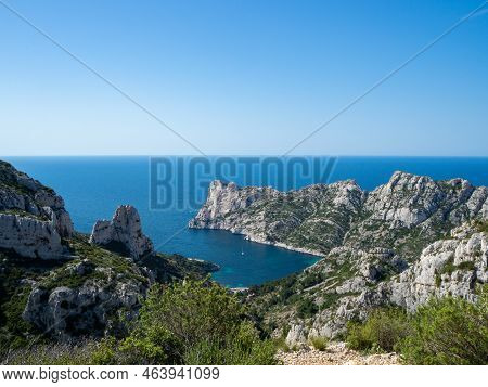 Calanques, France - May 20th 2020: Hiking High Above The Mediterranean Sea Along A Rocky Coast