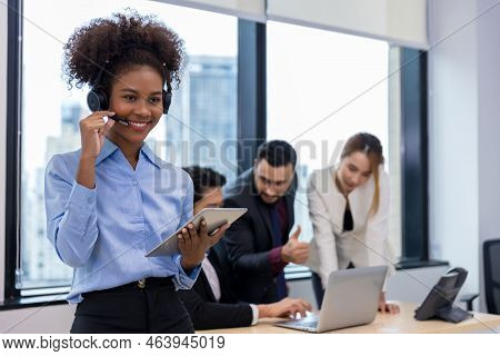 Call Center Business Woman Talking On Headset. Call Center Worker Accompanied By Her Team. Customer 